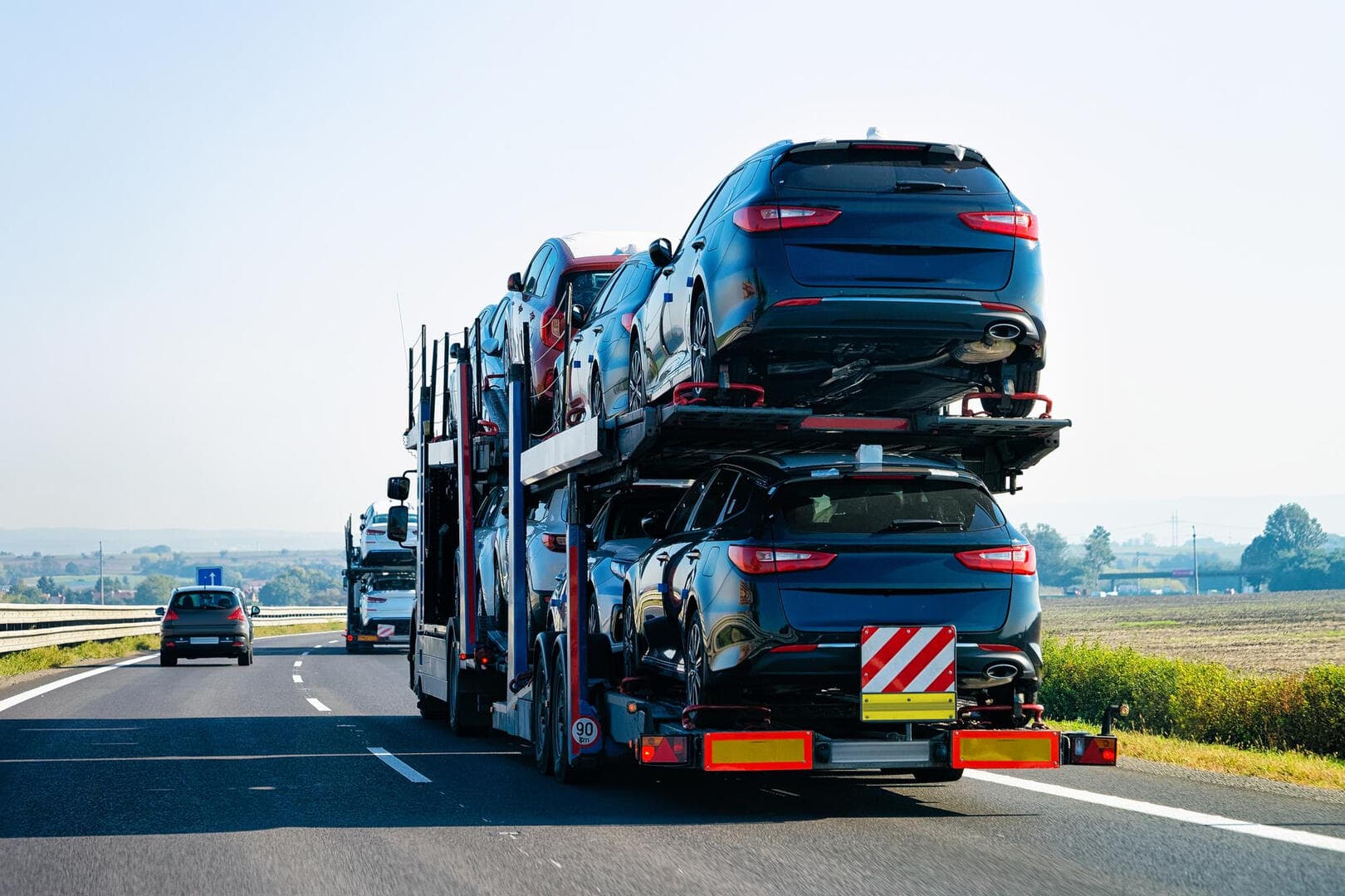 Truck carrier with cars on it